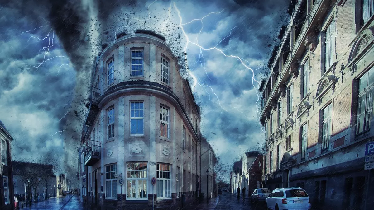 A dramatic scene of a tornado ripping through a city street, with debris flying through the air and buildings in the background.