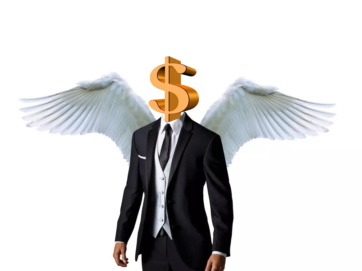 A man in a suit with a dollar sign for a head and angel wings.