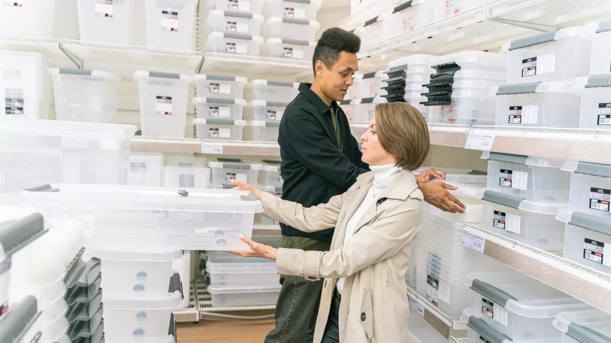 Two people are looking at a shelf of products in a retail store.