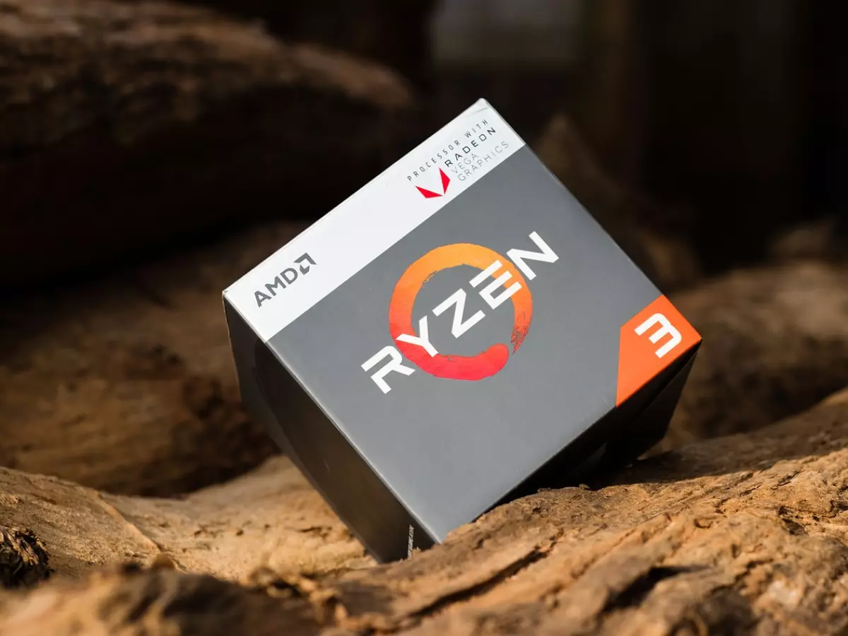 A close-up of a AMD Ryzen 3 CPU box on a wooden surface