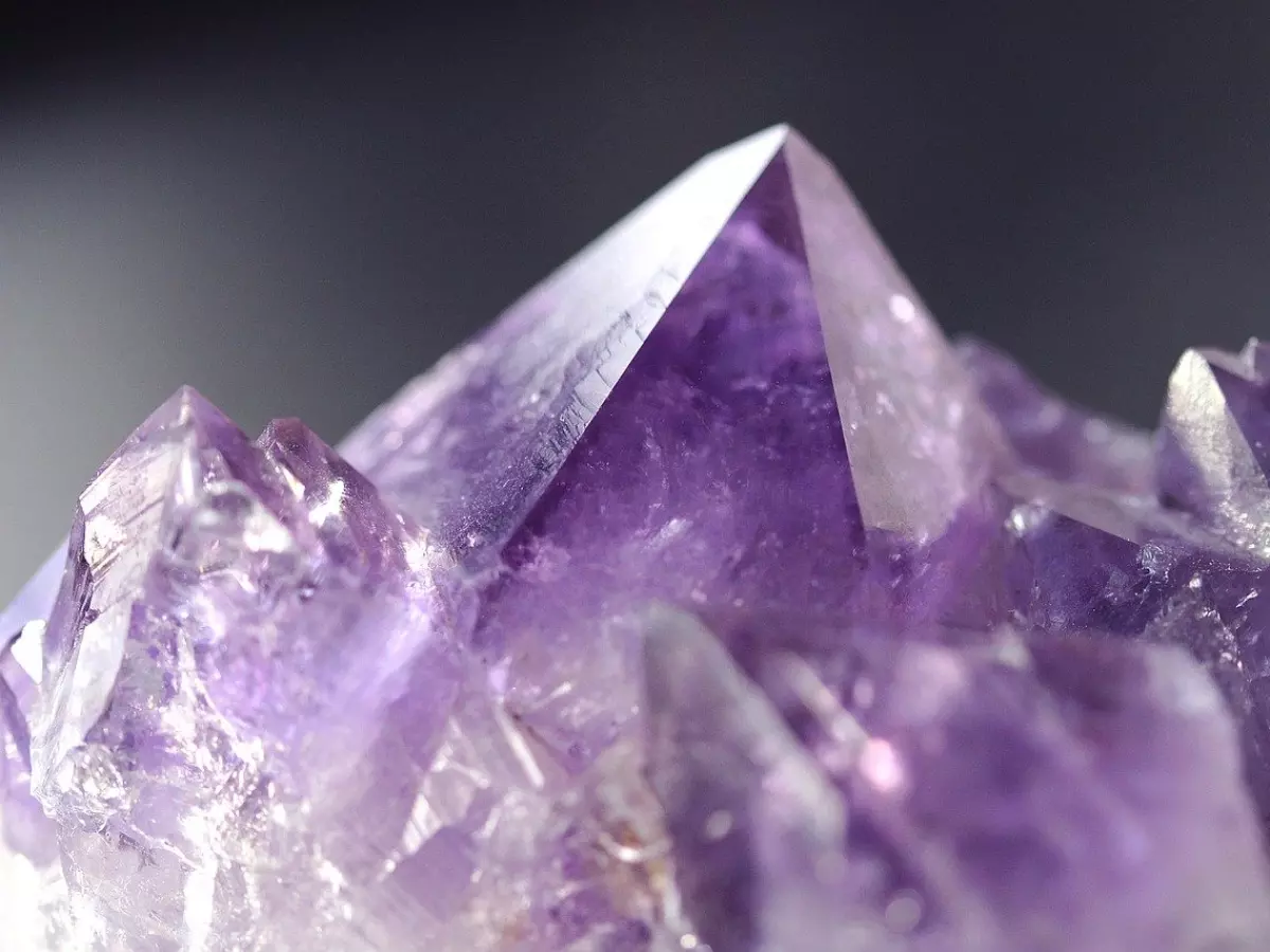 A close-up of a purple amethyst crystal.