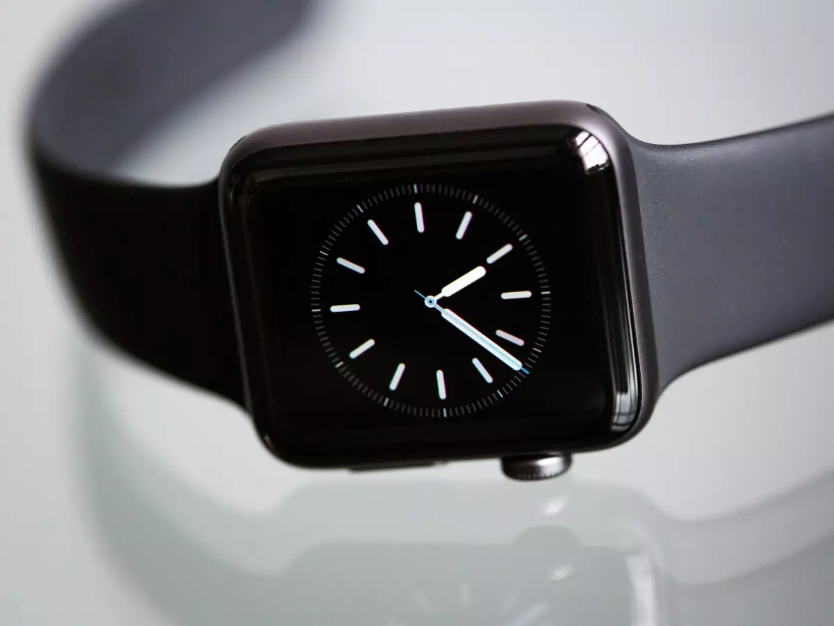 A close-up image of a black smartwatch with a silver bezel.