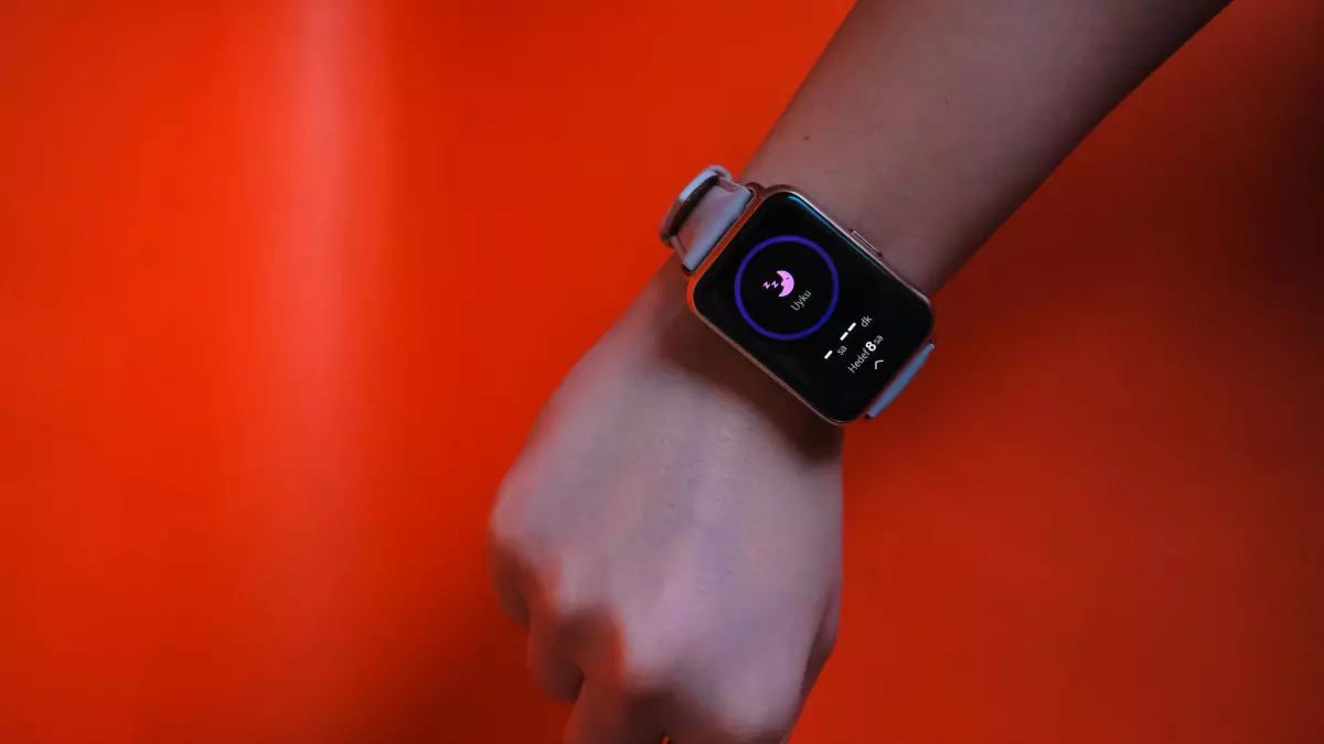 A person wearing a smartwatch on their wrist.