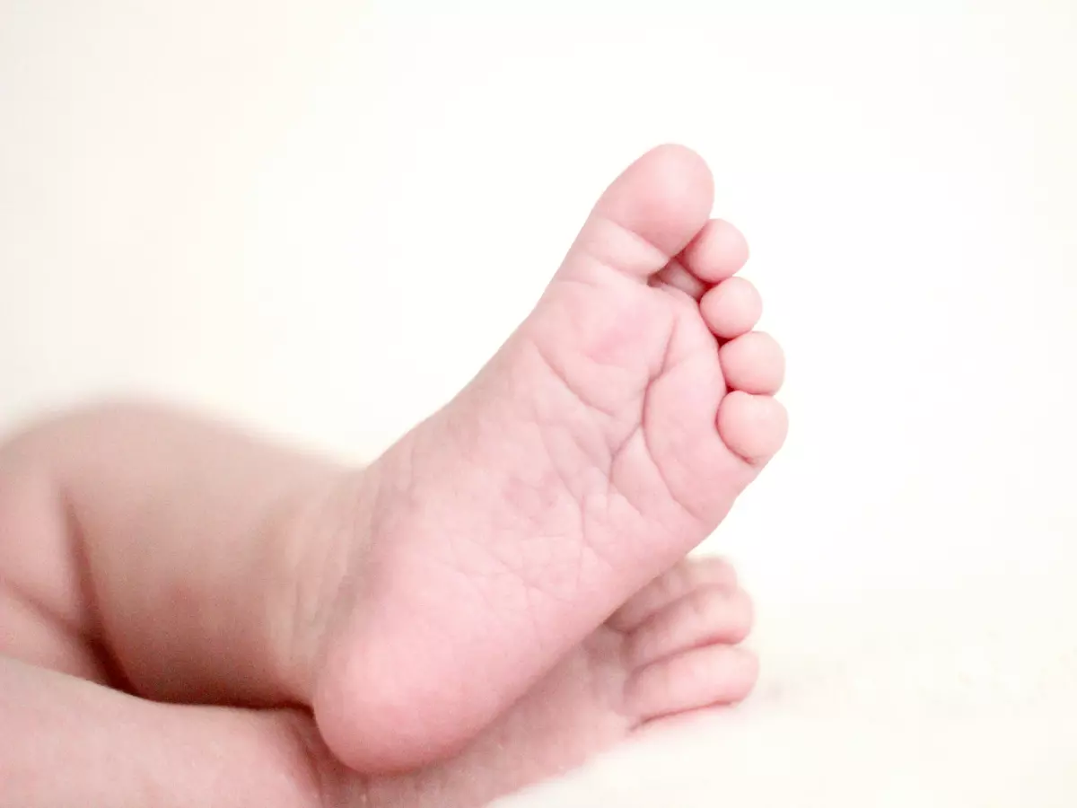 A close-up of the sole of a human foot, with visible wrinkles and lines.