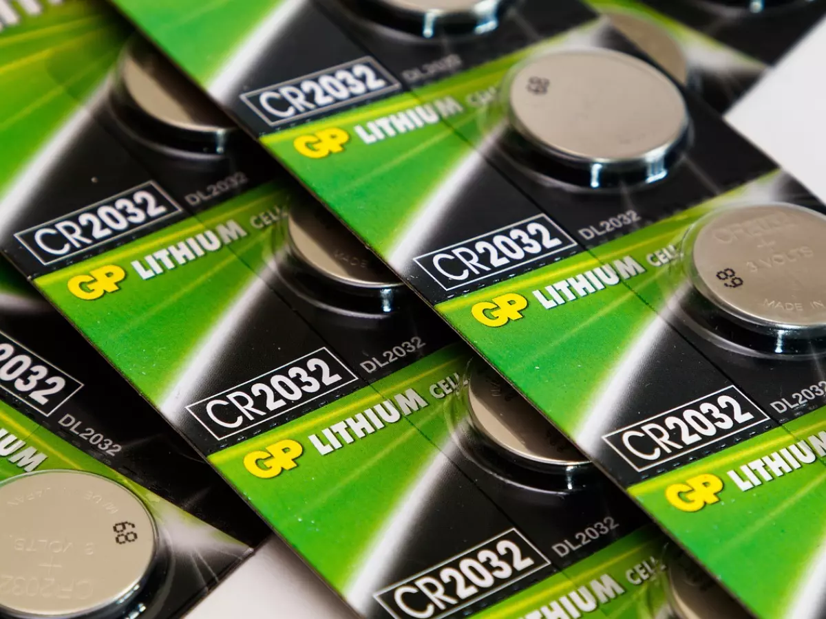 A close-up shot of multiple packages of CR2032 lithium batteries.