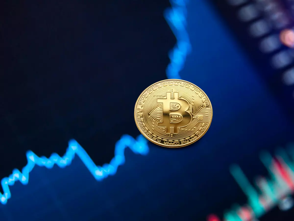 A golden Bitcoin coin positioned on top of a stock chart, capturing the upward trend of the market.