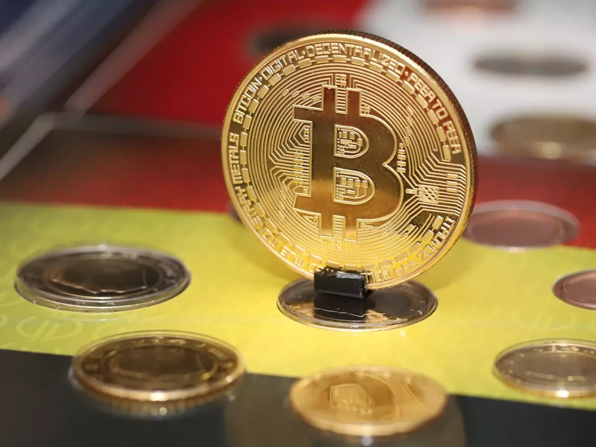 a bitcoin coin in the center surrounded by other coins