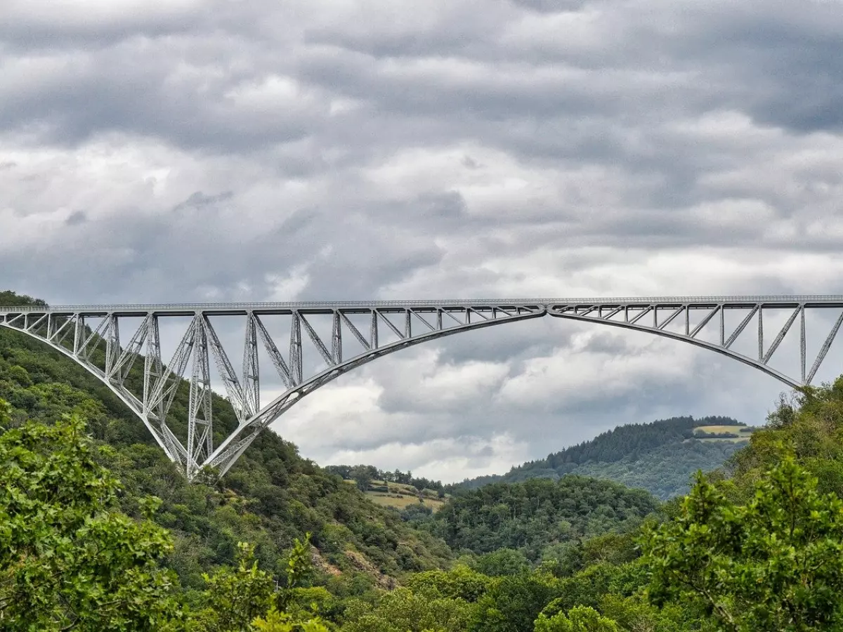 A large steel bridge with a single arch spanning a valley.