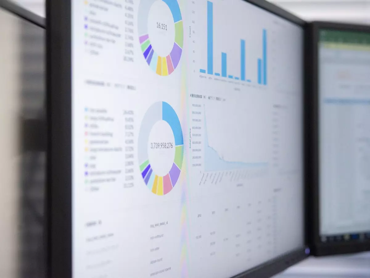 Close-up of a screen with multiple charts and graphs. Blue and white are the dominant colors.