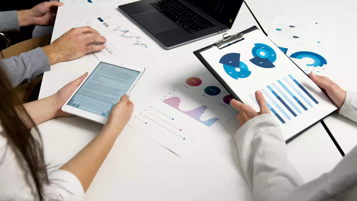 A group of people working on a project with data charts. It’s relevant to the article as it shows the need for efficient big data compression.