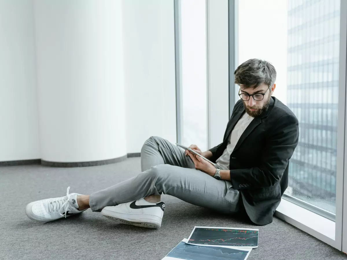 A man holding a phone with a blockchain app open.