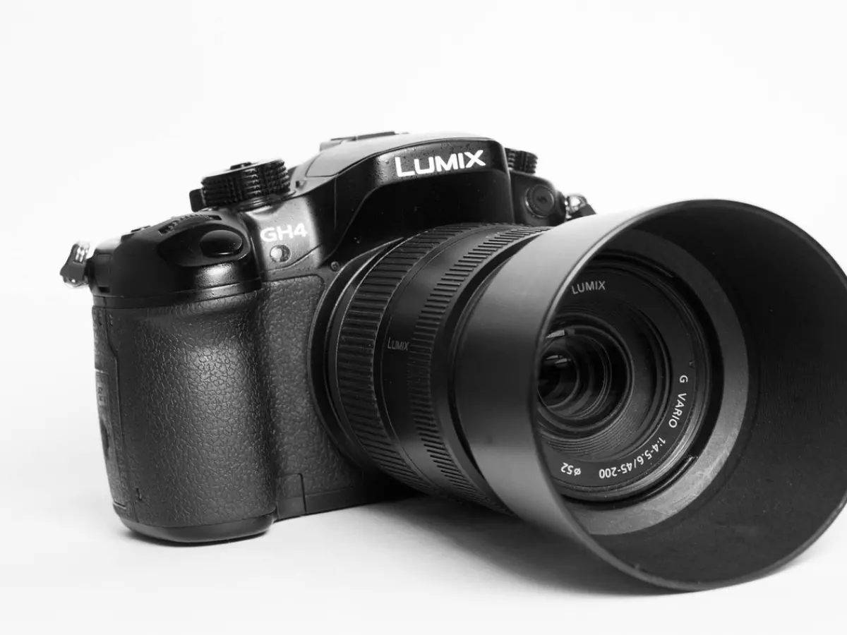 A black camera with a lens attached, branded with 'LUMIX'.