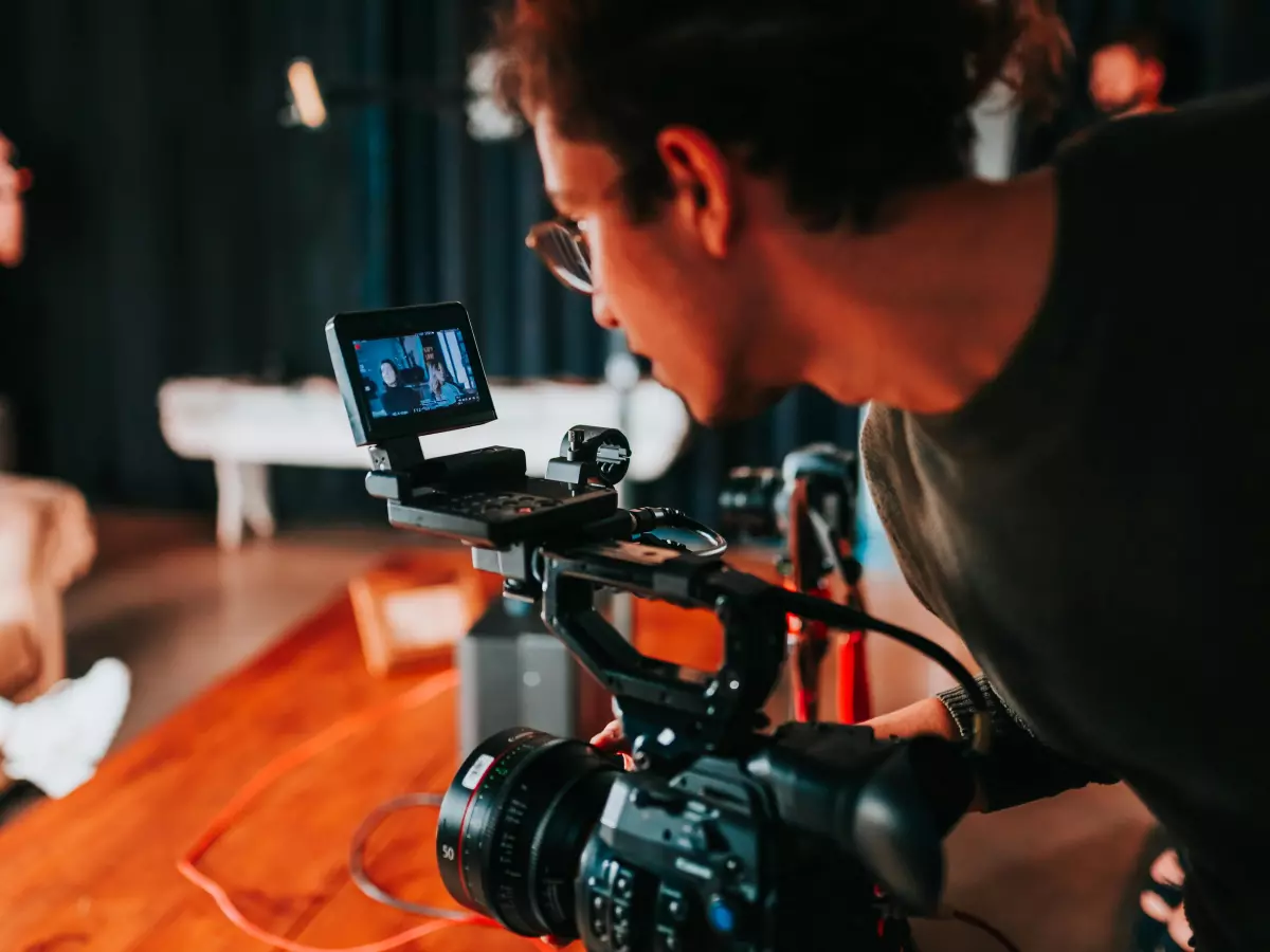 A videographer filming a scene with a professional camera.