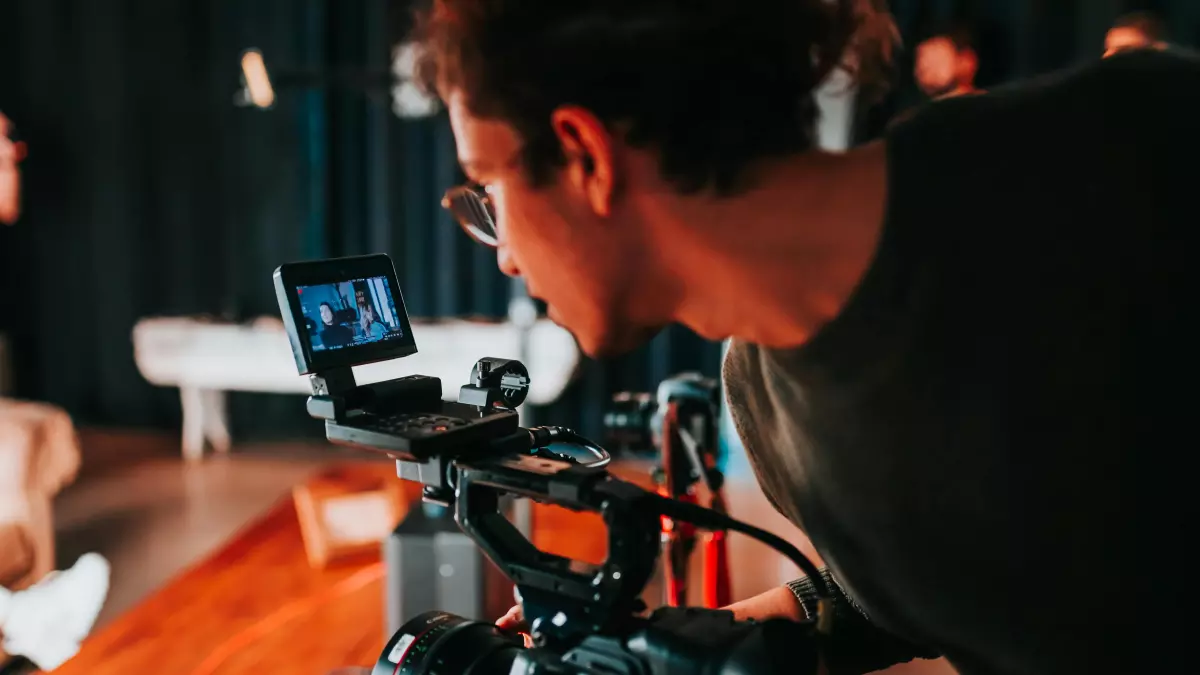 A videographer filming a scene with a professional camera.