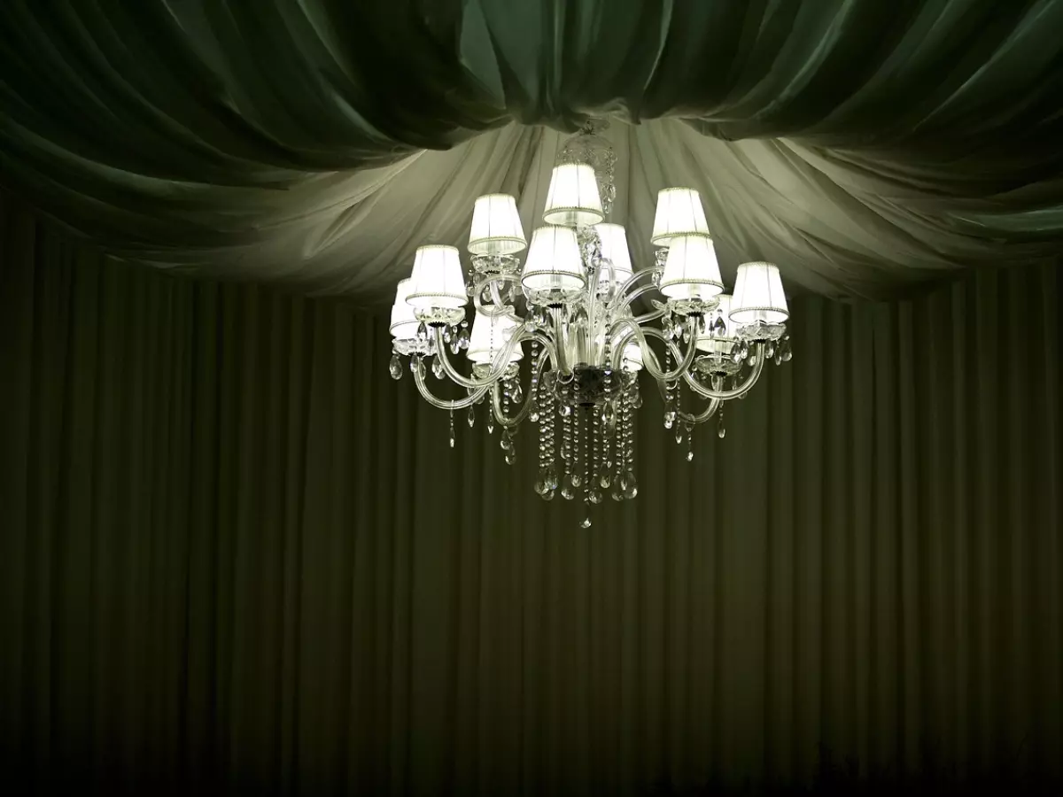 A chandelier hangs from the ceiling of a room.