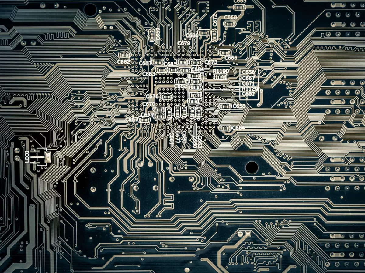 A close-up image of a circuit board, showcasing intricate details of chip manufacturing.