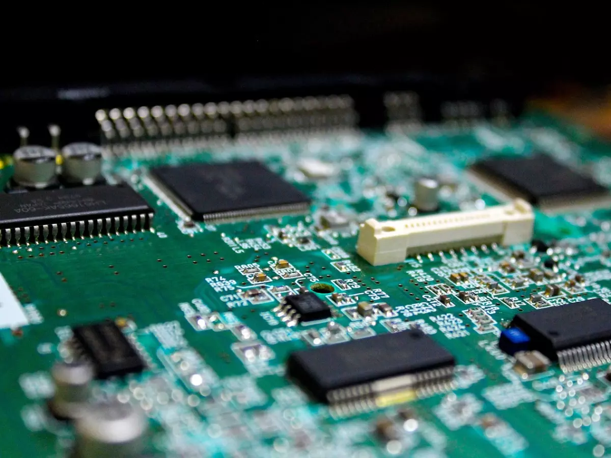 A close-up shot of a circuit board, showcasing the intricate network of chips, wires, and components.