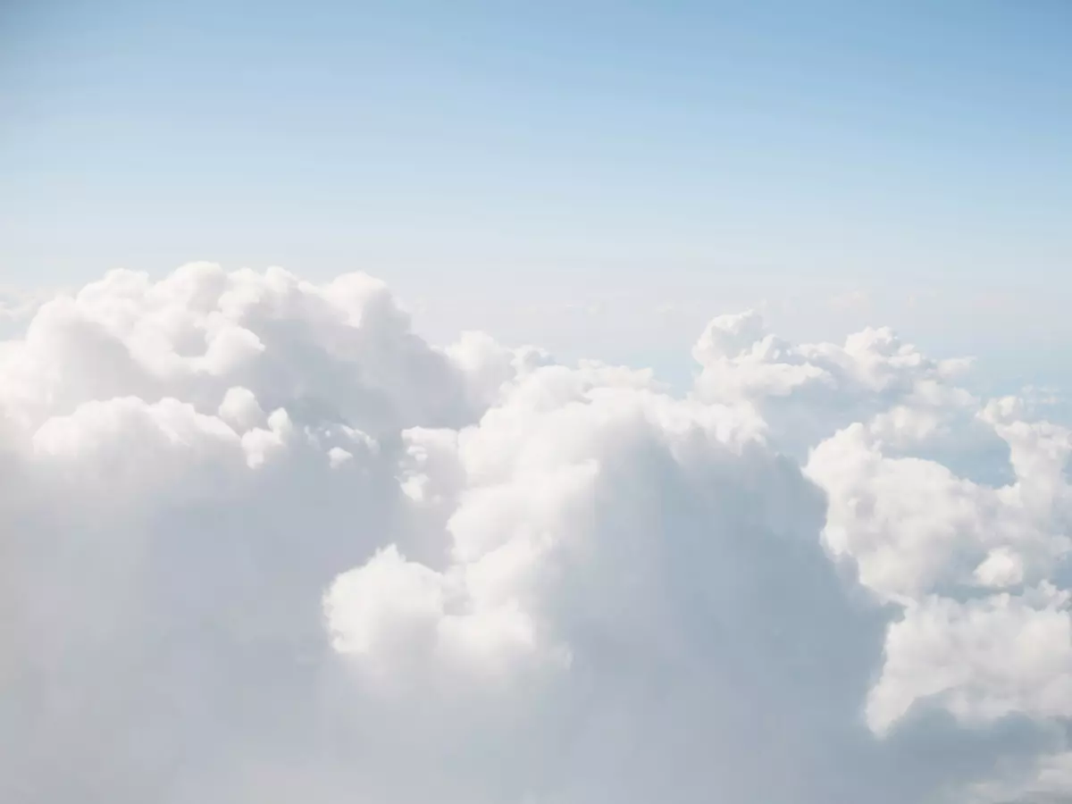 A wide shot of a bright sky filled with white clouds.