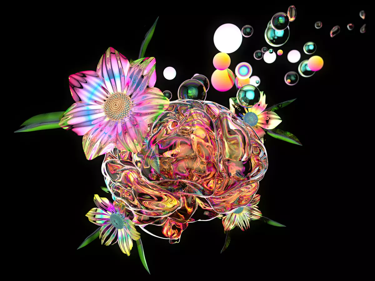 A glass brain with flowers and bubbles on a black background. The flowers are pink and yellow, and the bubbles are in various shades of blue and orange.