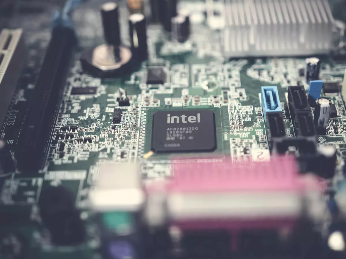 A close-up shot of an Intel chip on a motherboard, with the text 'Intel' clearly visible. The image is taken from a slightly angled perspective, showing the chip in its context on the board.