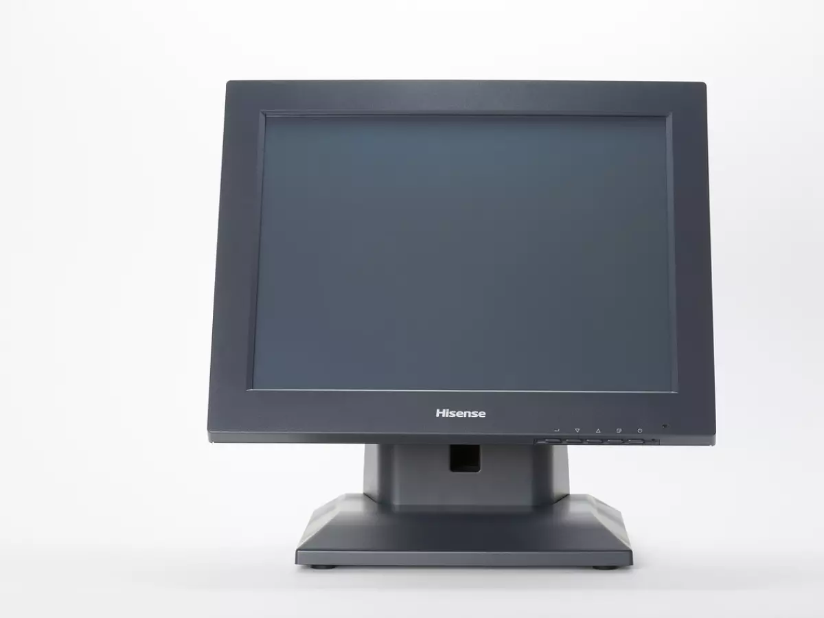 A Hisense TV with a black bezel is sitting on a stand.