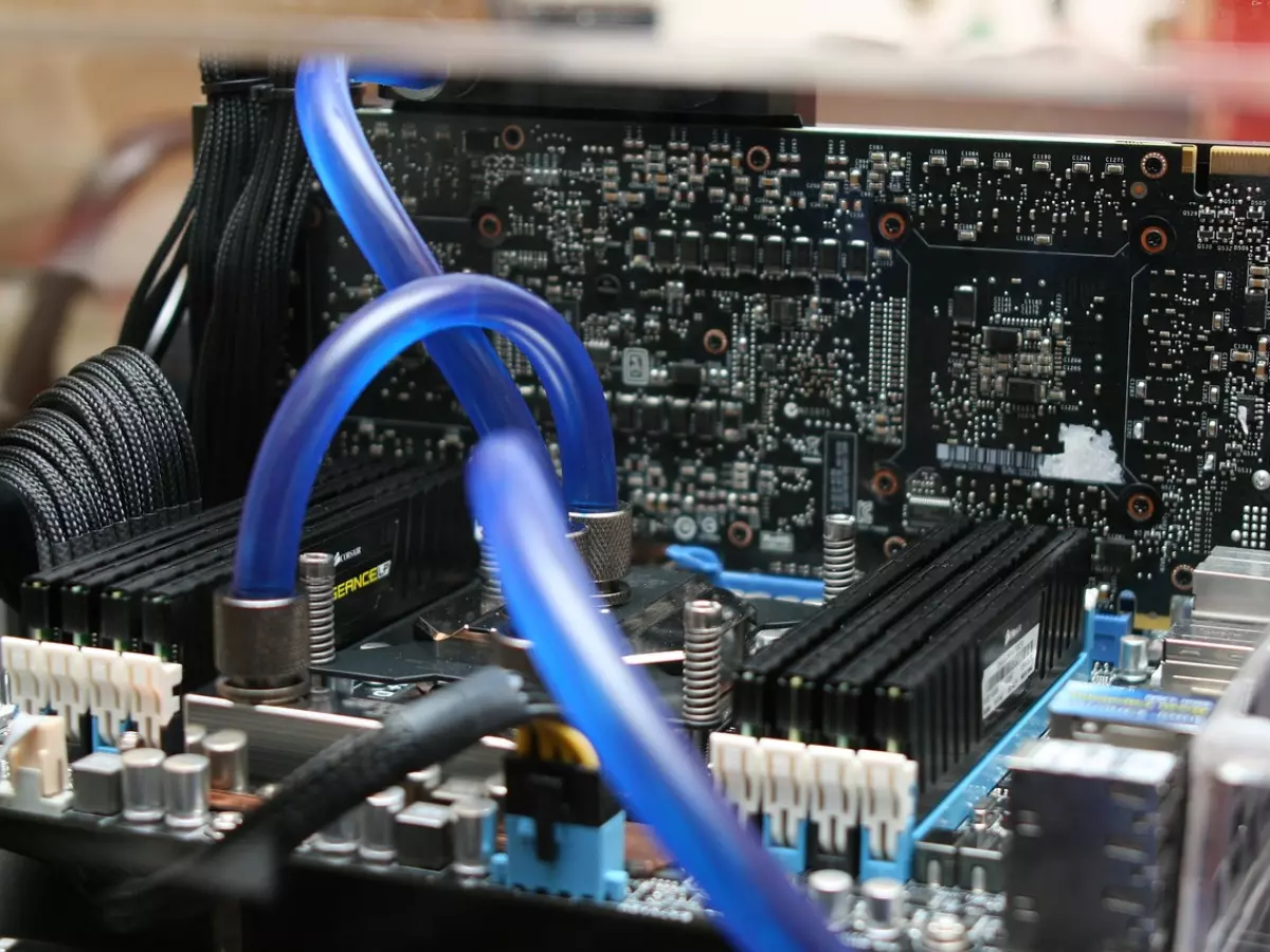 Close up of a motherboard with blue water cooling tubes