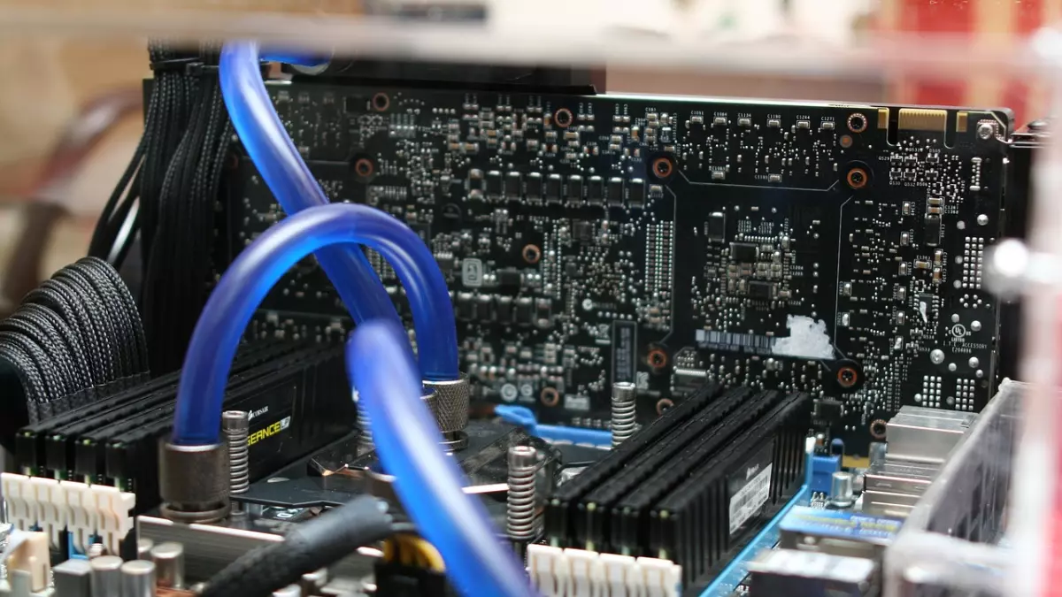 Close up of a motherboard with blue water cooling tubes