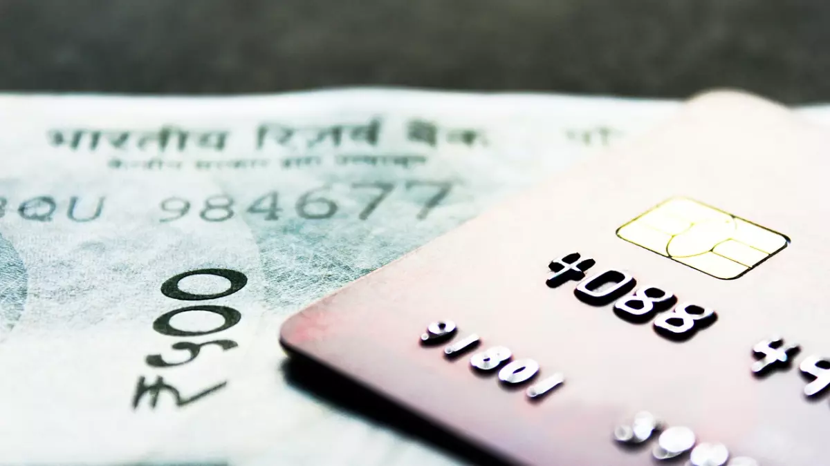 A credit card on top of an Indian rupee banknote