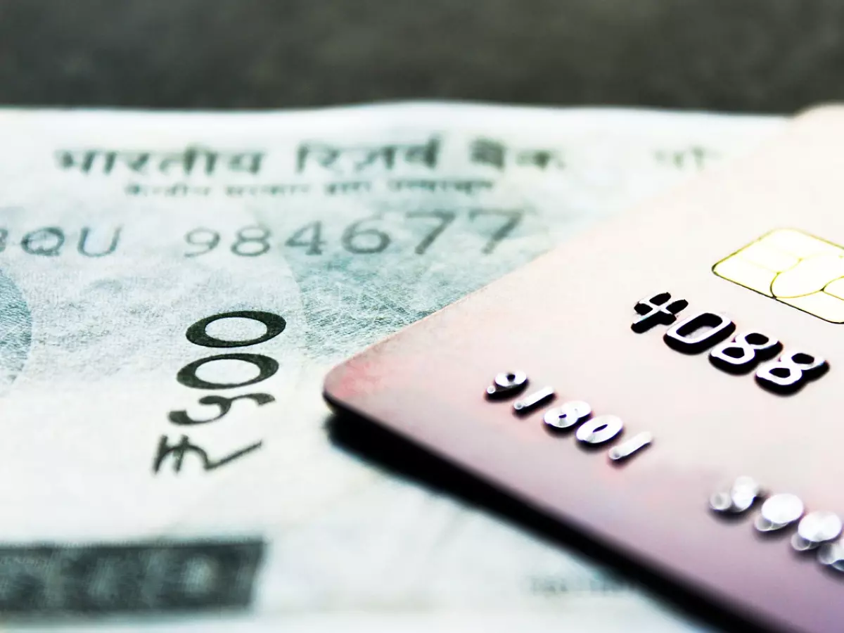 A credit card on top of an Indian rupee banknote