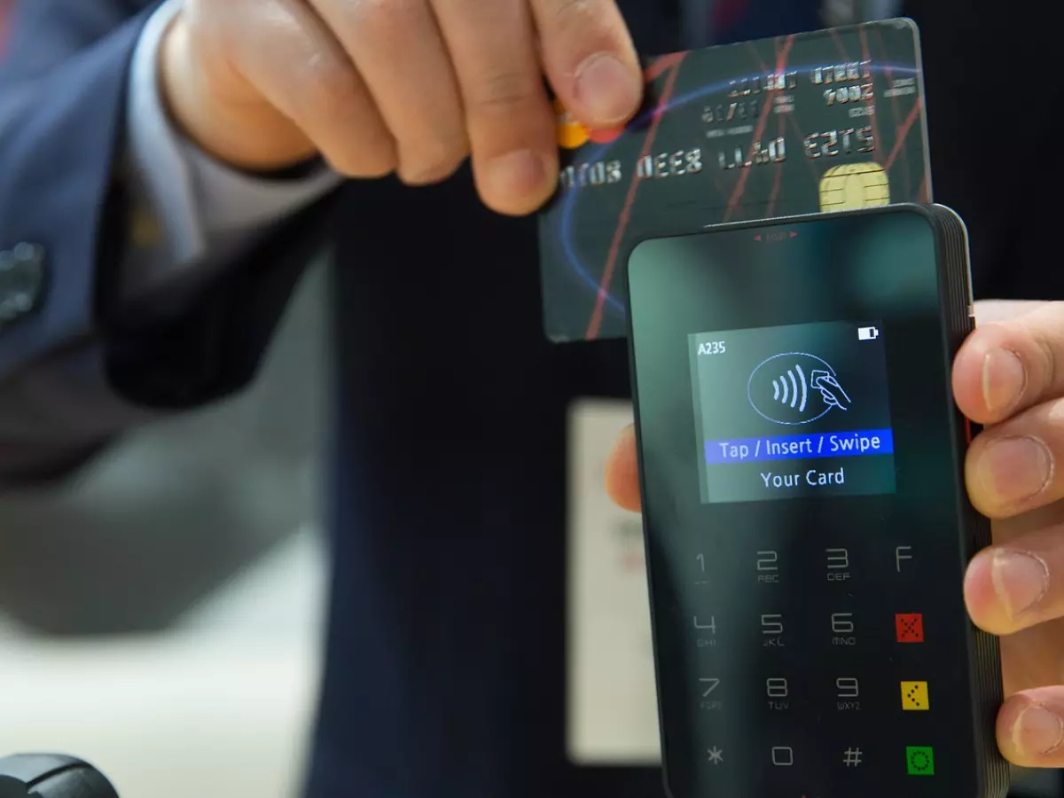 Close up of a person using a card payment terminal.