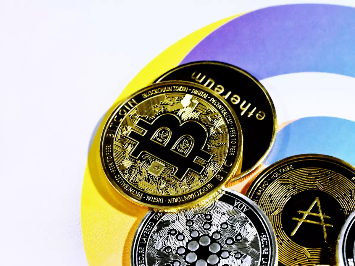 A close-up shot of various cryptocurrency coins including Bitcoin and Ethereum on a colorful background.