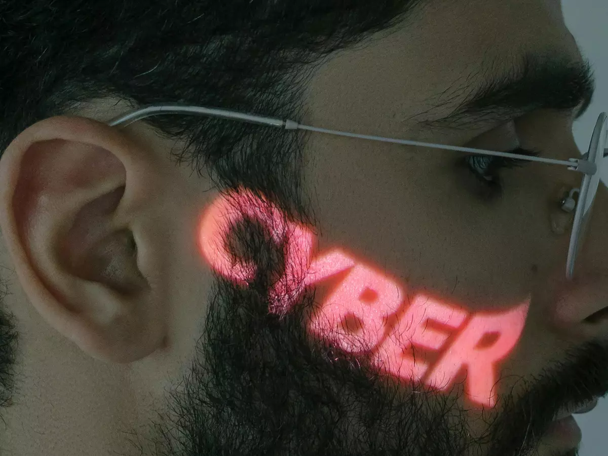 A close-up shot of a man's face with the word 'CYBER' projected in red over his face, highlighting the theme of cybersecurity and AI.