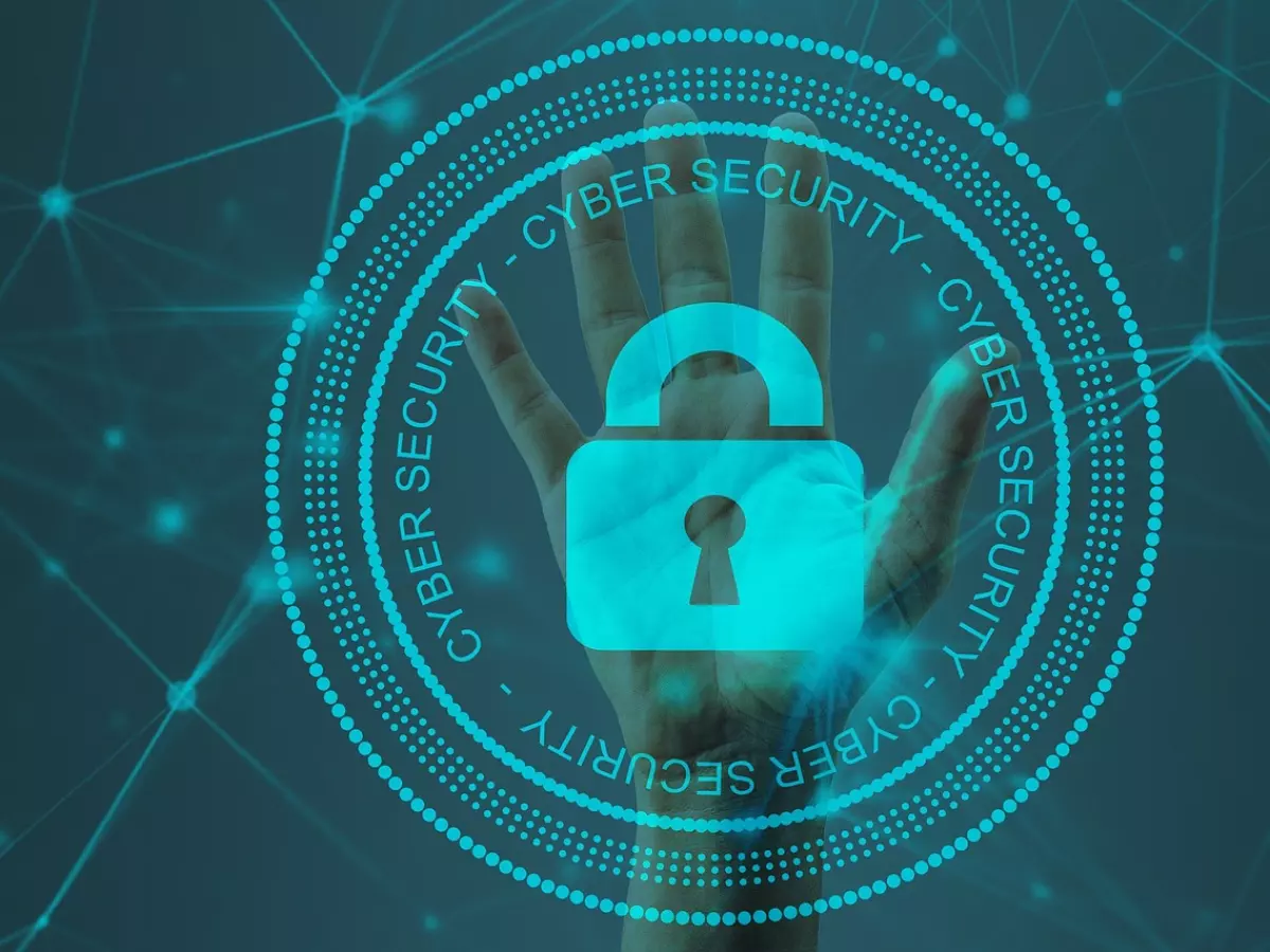 A hand with a padlock in front of a blue background with a network pattern.