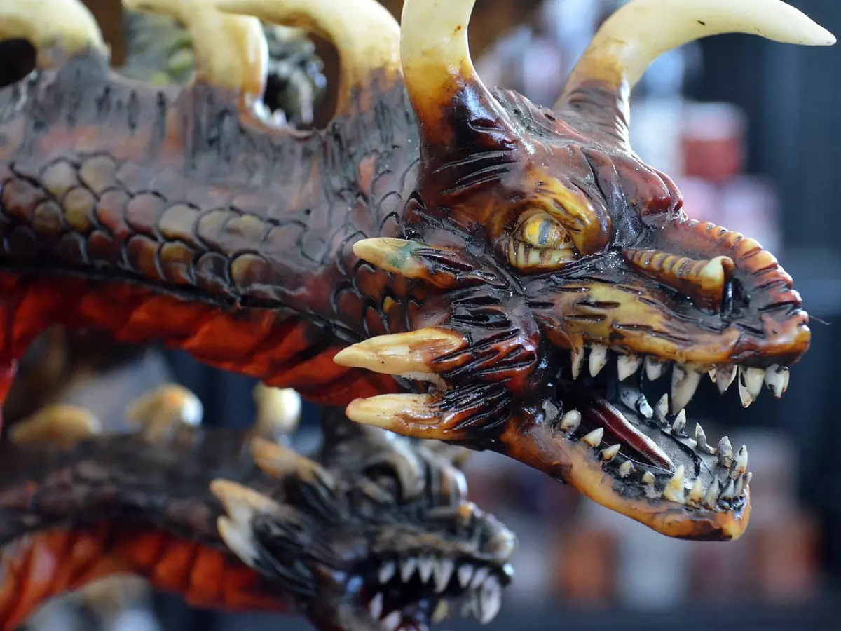 A close-up of a dragon sculpture, showing its teeth and claws.