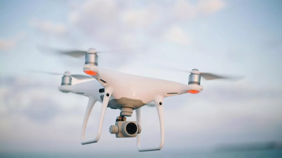 A drone in flight, captured from below, showing its camera lens and propellers.