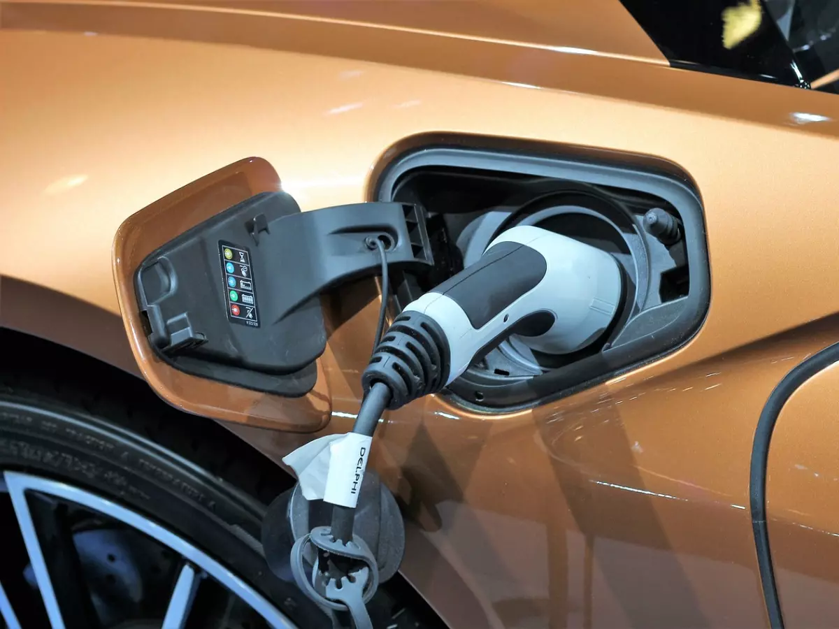 A close-up of an electric car charging, showcasing the charging port and cable.