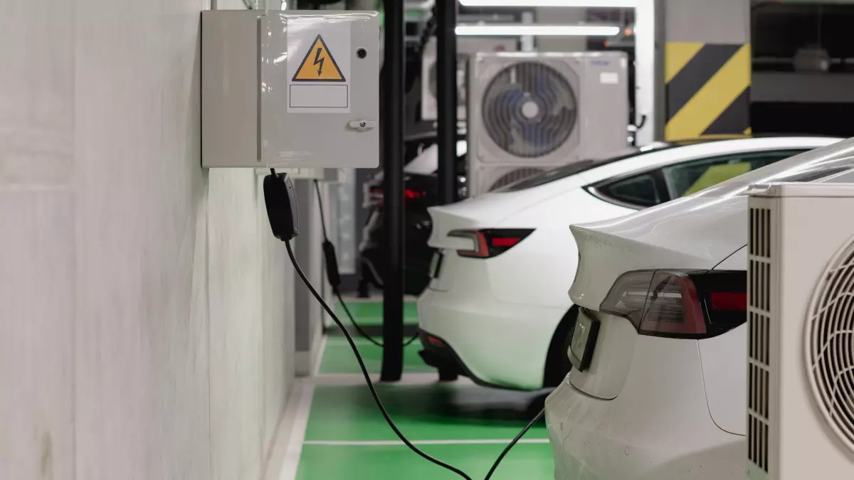 Multiple electric vehicles charging in a parking garage. The image depicts multiple EVs, each with a charging cable plugged into the vehicle, suggesting a setting focused on electric vehicle charging.