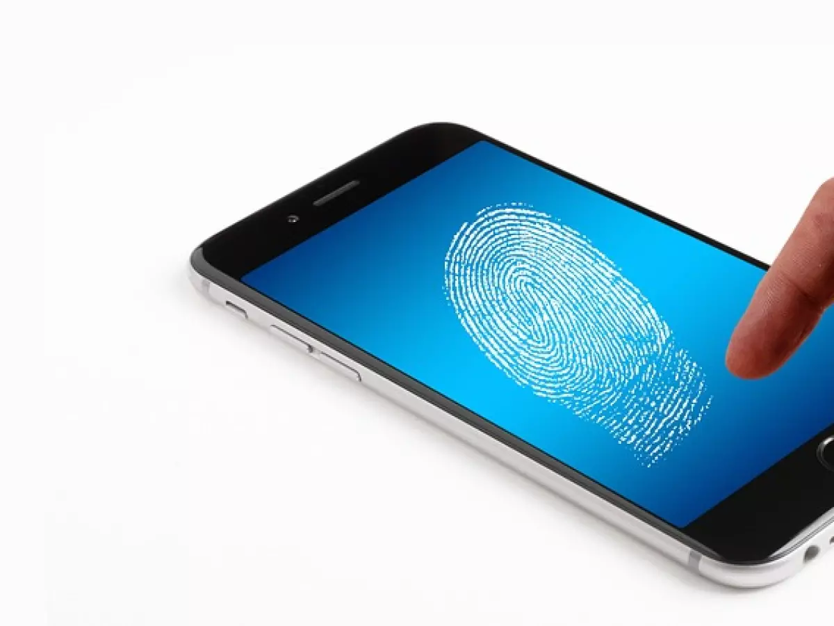 Hand using fingerprint scanner on a smartphone