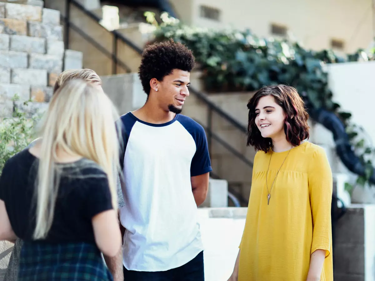 Group of people laughing and chatting in a casual setting.