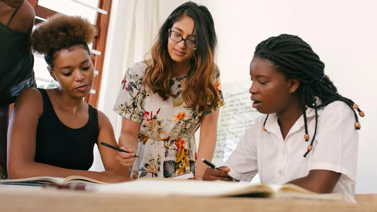 A group of diverse women working together on a project.