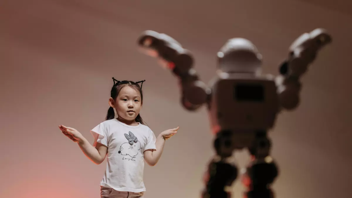 A humanoid robot stands in the background, while a young girl dances in the foreground.