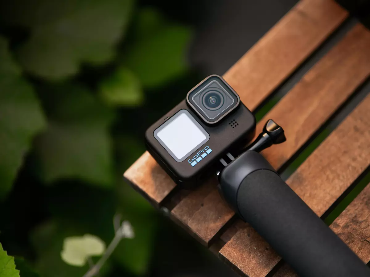 A close-up of the GoPro Hero 13 Black camera mounted on a tripod. The camera is positioned in a way that emphasizes its front screen and lens.