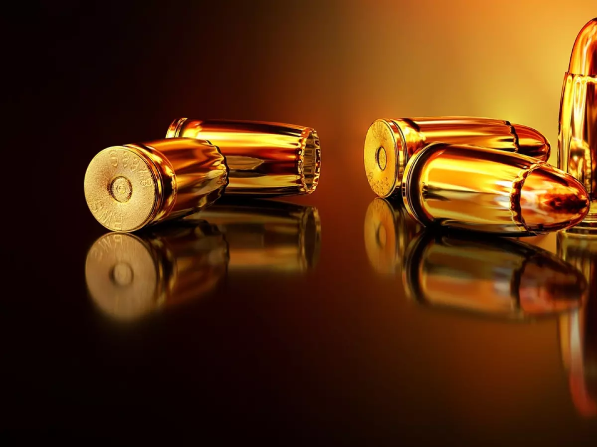 Golden bullets on a dark background, reflecting light.