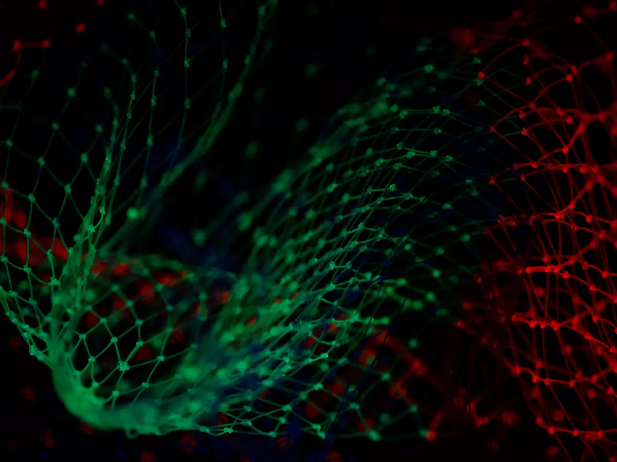 An abstract image of a network with red and green lights, the lines of the network are thin, making the lights appear like stars in the night sky