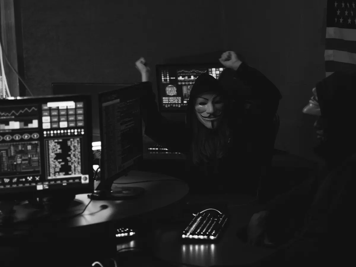 A person looking at a computer in an office setting.