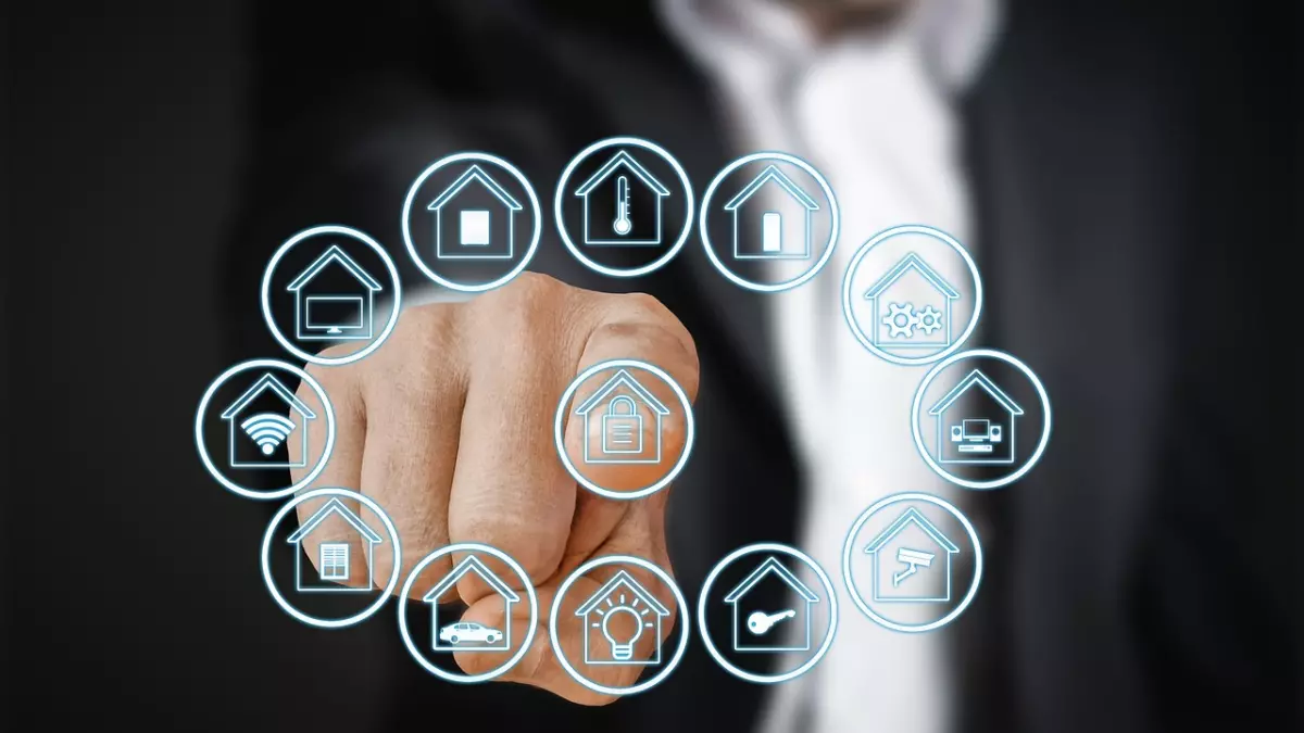 A man in a suit pointing his finger at a virtual display of smart home icons. The icons represent various aspects of a smart home, including a light bulb.