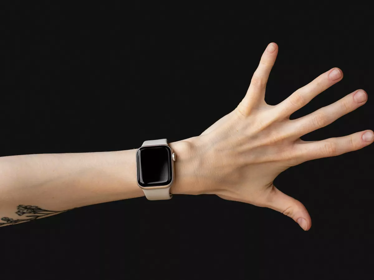 A hand wearing a smartwatch.