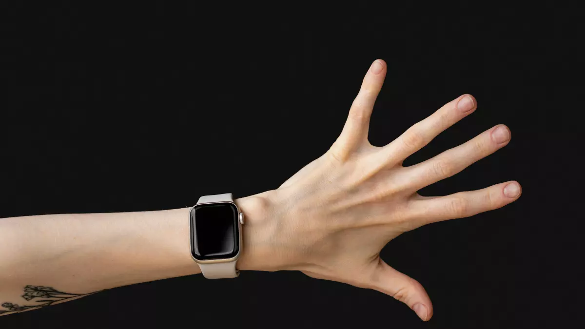 A hand wearing a smartwatch.