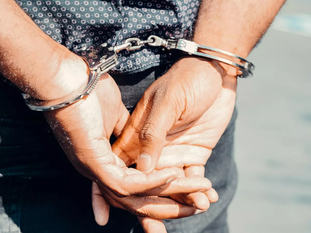 A person's hands in handcuffs, a close-up shot.