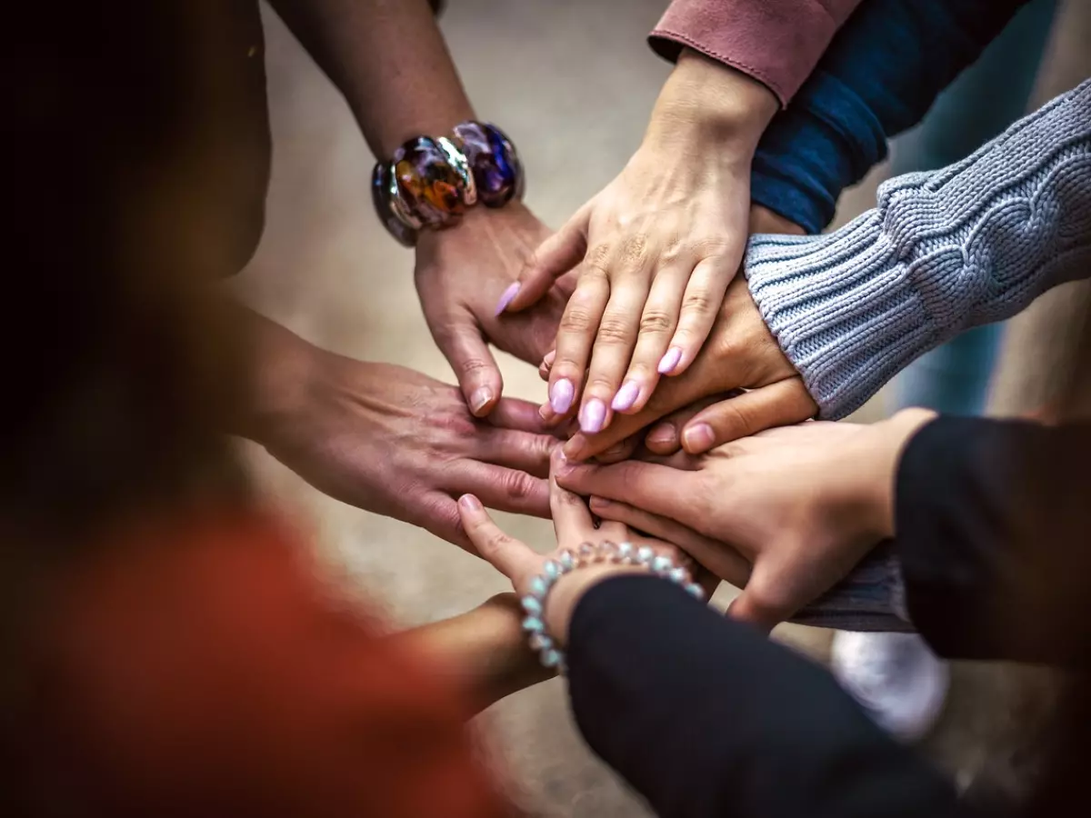 Hands clasped together in a circle.